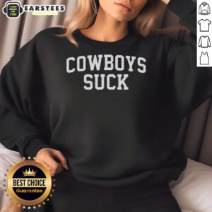Fan wearing a 'Cowboys Suck' sweatshirt at the Chiefs vs Lions game, showcasing team spirit and sports enthusiasm.