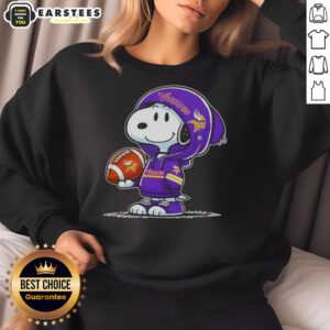 Alt Text: Cute Snoopy wearing a Minnesota Vikings hoodie, smiling at fans while showcasing a cozy sweatshirt design.