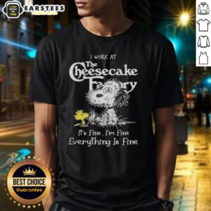 Alt Text: Funny tired Snoopy and Woodstock graphic on a t-shirt saying 'I work at The Cheesecake Factory, it's fine'.