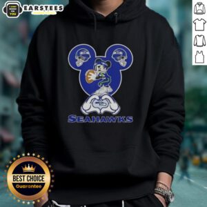 Good Mickey hands making a heart shape in a Seattle Seahawks football hoodie, showcasing team spirit and love.