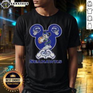 Good Mickey hands forming a heart on a Seattle Seahawks football T-shirt, perfect for fans showing love for their team.