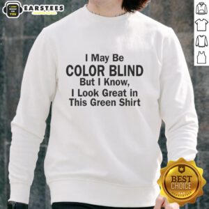 Man wearing a green sweatshirt humorously claiming color blindness, showcasing his vibrant green outfit.