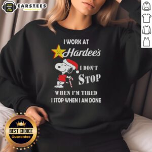 Funny Snoopy sweatshirt featuring 'I work at Hardee's, I don't stop when I'm tired, I stop when I'm done' Christmas design.