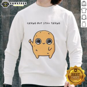 Pretty sad nuggie cartoon mascot crying but trying, featured on a cozy sweatshirt for a fun and unique style.