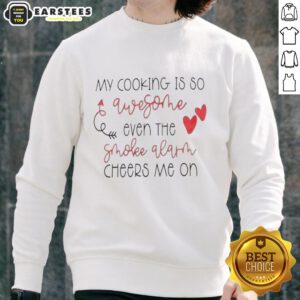 Funny sweatshirt saying 'My Cooking Is So Good, Even The Smoke Alarm Cheers Me On' for cooking enthusiasts and humor lovers.