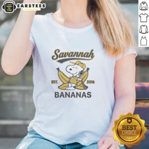 Alt Text: Snoopy lying on a banana, wearing a Savannah Bananas outfit, featured on a ladies tee from Est. 2016.