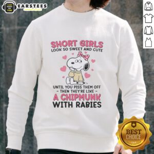 Cute girl in a pink bow sweatshirt featuring Snoopy, showcasing a sweet and stylish look.