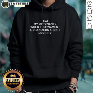 Man wearing 'I Eat My Opponents When Tournament Organizers Aren't Looking' hoodie, showcasing gaming humor and style.