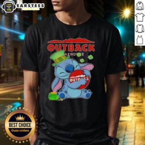 Alt Text: Cute Stitch hugging Outback Steakhouse logo on a Happy St. Patrick's Day t-shirt, perfect for festive celebrations.