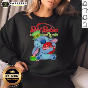 Cute Stitch hugging a red robin logo on a Happy Patrick's Day sweatshirt, perfect for festive celebrations.