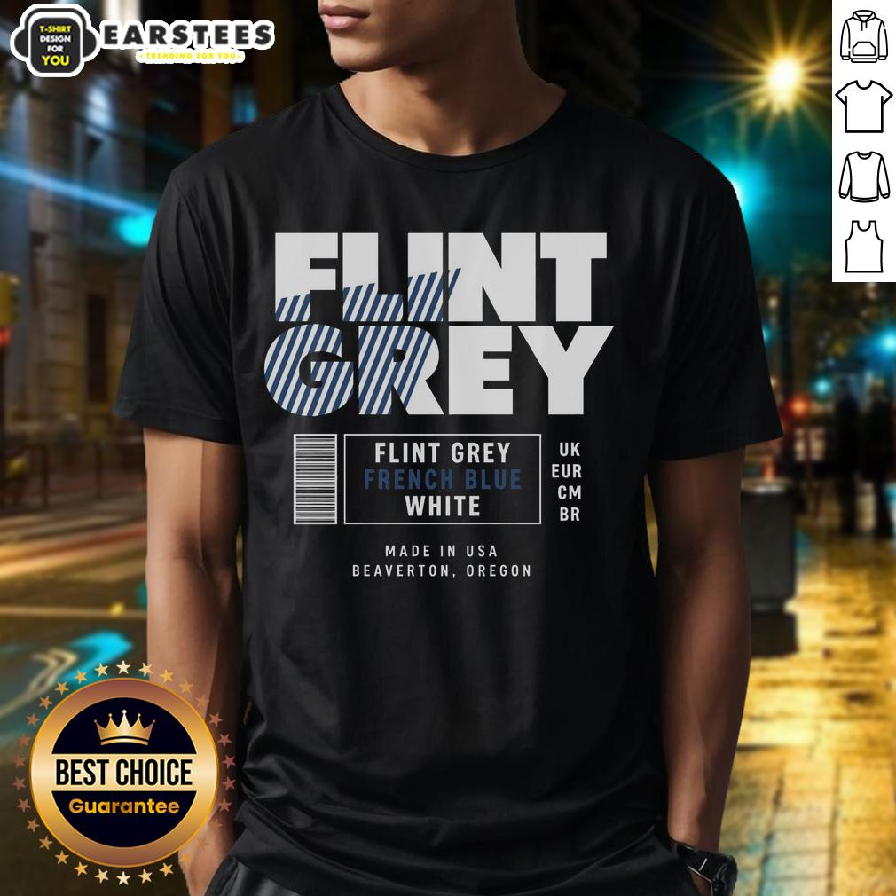 Good Flint Grey French Blue White Label T-Shirt displayed on a wooden surface, showcasing its stylish design and fabric.