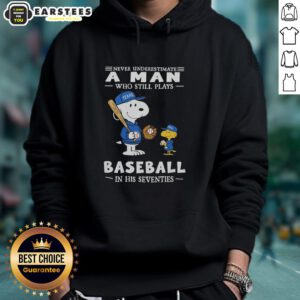 Alt Text: Cute Peanuts X Texas Rangers hoodie featuring 'Never Underestimate A Man Who Still Plays Baseball In His Seventies' design.