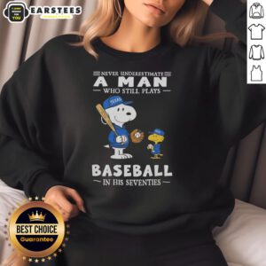 Alt Text: Cute Peanuts X Texas Rangers sweatshirt featuring 'Never Underestimate A Man Who Still Plays Baseball In His Seventies' design.