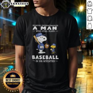 Alt Text: Cute Peanuts X Toronto Blue Jays t-shirt featuring the phrase Never Underestimate A Man Who Still Plays Baseball In His Seventies.