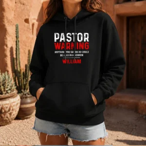 Original Pastor Warning Hoodie in black, featuring bold white text on front, displayed on a front-facing model